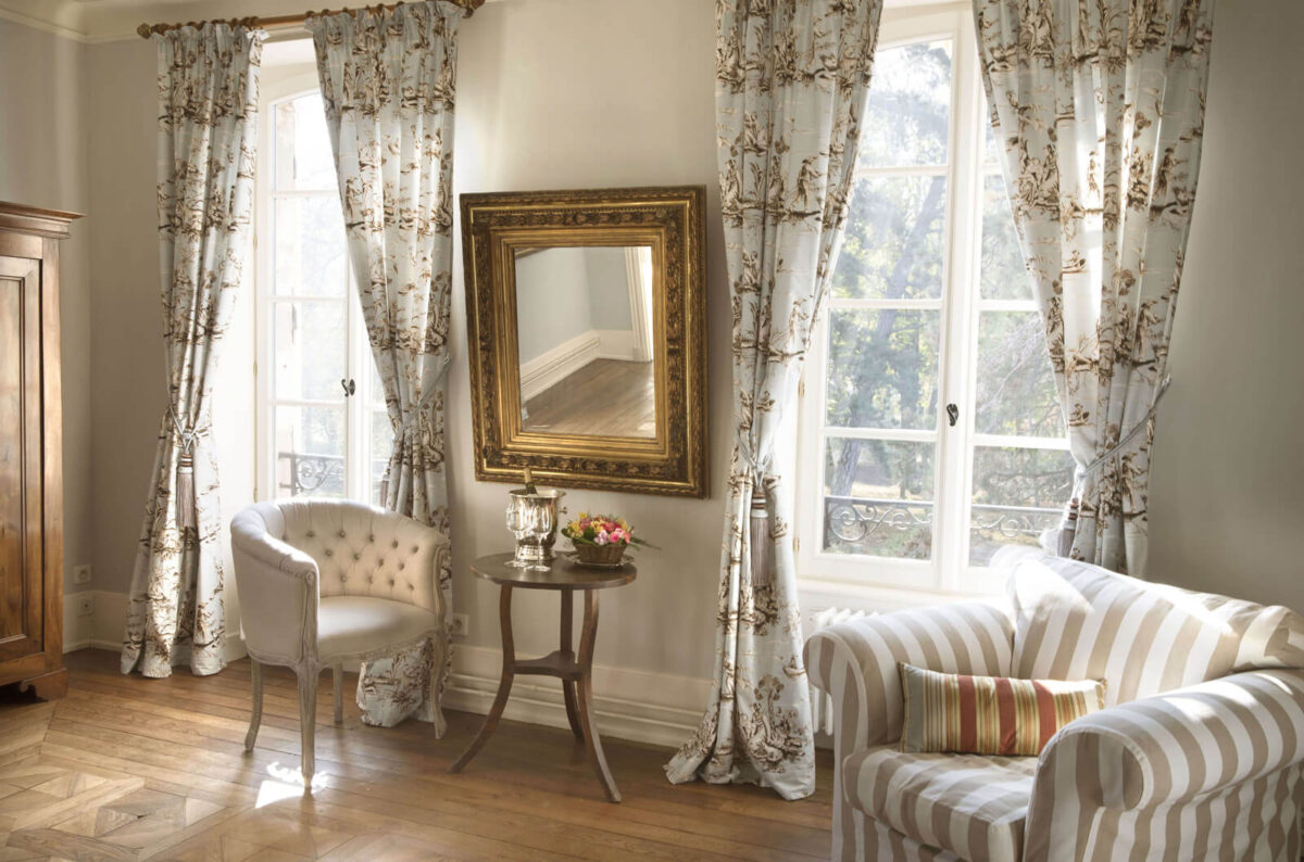 The Bleue suite — high ceilings, soft natural light, restored period detail.