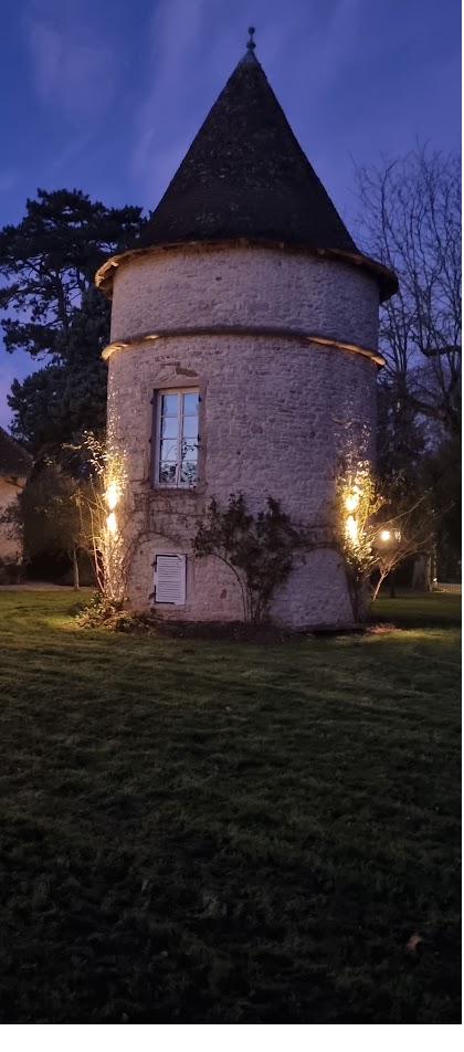 The old tower lit at dusk during an evening reception.