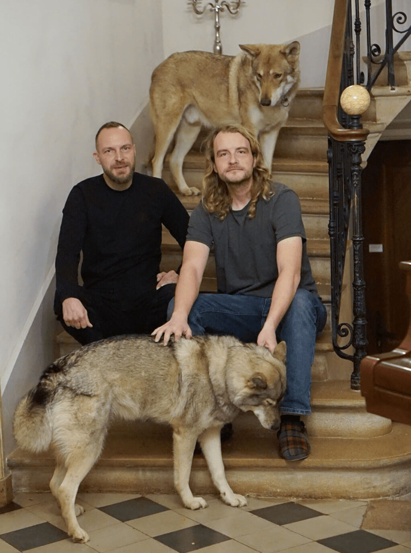 The Münch brothers on the château staircase, with two of the dogs.