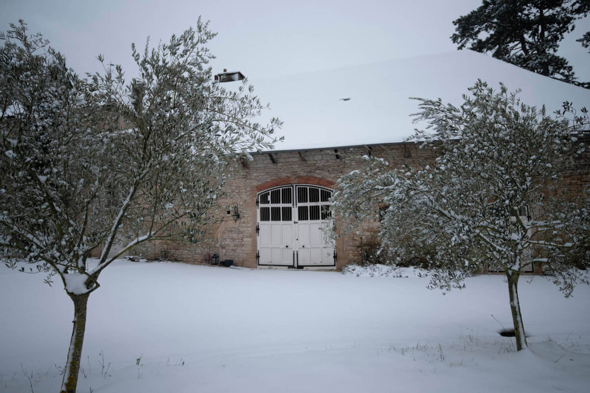Snow on the courtyard and barn in winter.